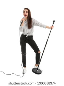 Young Woman In Casual Clothes Singing With Microphone On White Background