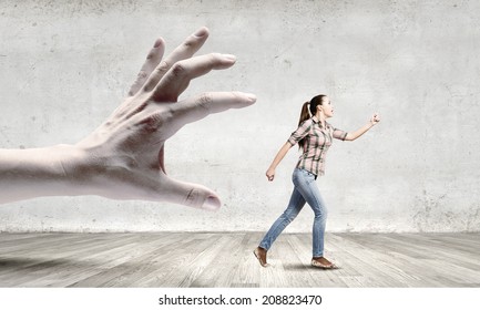 Young woman in casual escaping from big male hand