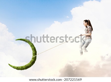 Young woman in casual holding moon on lace