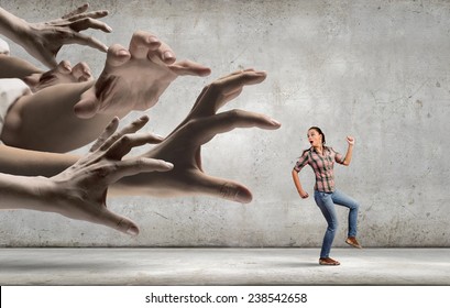 Young Woman In Casual Running Away From Big Hand