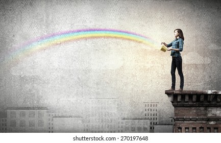 Young Woman In Casual Splashing Rainbow From Bucket