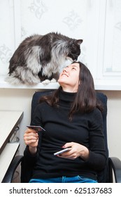 Young Woman And Cat Buy Things Online With Credit Card And Smart Phone. Shopping Concept