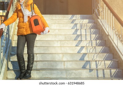 Young Woman With Cat In Carrier Bag On Stairs