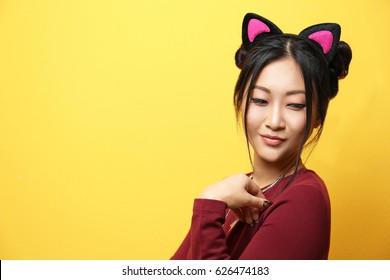 Young Woman In Cat Ears On Color Background