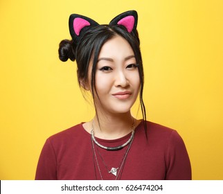 Young Woman In Cat Ears On Color Background