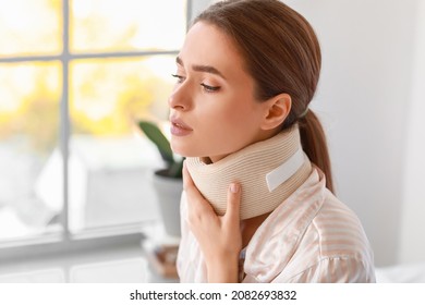 Young Woman With Cervical Collar On Neck At Home