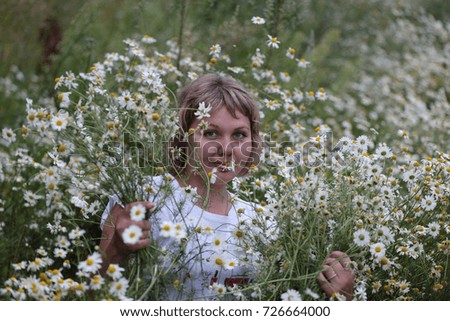 Similar – eine frau vor  einer blumenwiese. blumen pflücken