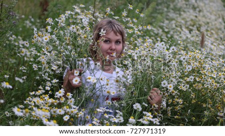 Similar – eine frau vor  einer blumenwiese. blumen pflücken