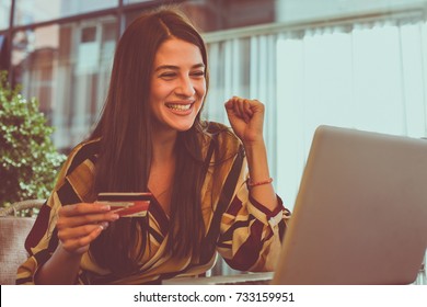 Young Woman Checking Account On Credit Card. She Is Happy.   