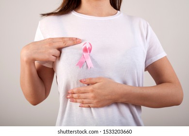 young woman checking her breast for breast cancer - Shutterstock ID 1533203660