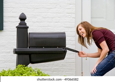 Young Woman Checking For Mail