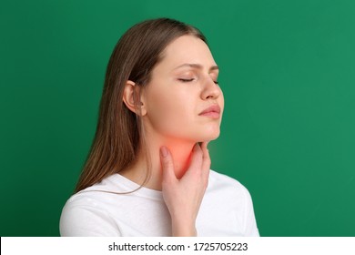 Young woman checking thyroid gland on color background