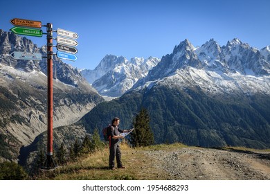 A Young Woman Is Checking A Trail Map In The Mountains Near A Ski Resort Town Of Chamonix In France