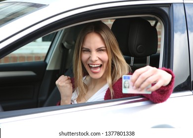 Young woman cheers about her obtained driver's license