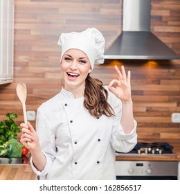 Young Woman Chef Cooking Cake In Kitchen