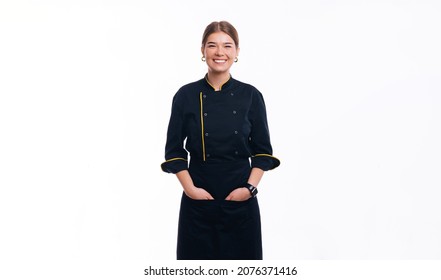 Young Woman Chef Posing At Camera, Wearing Uniform, Hands In Pockets, 