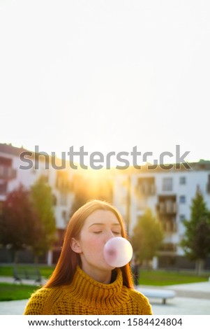 Similar – Junges Teenagermädchen, das rosa Kaugummi bläst.