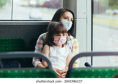 Young Woman With A Child In A Public Bus Protected Wearing A Protective Mask On Her Face