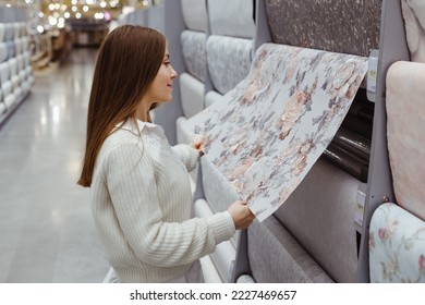 Young woman choose wallpaper in hardware store. Home design and renovation concept. - Shutterstock ID 2227469657