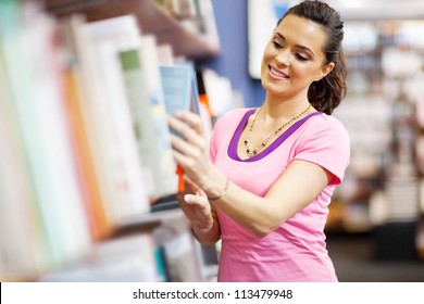 Young Woman Choosing A Book In Bookstore