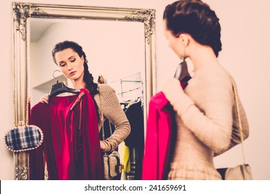 Young Woman Choosing Clothes In A Showroom 