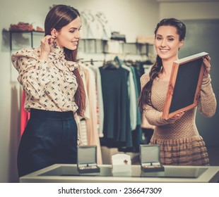 Young Woman Choosing Jewellery With Shop Assistant  Help