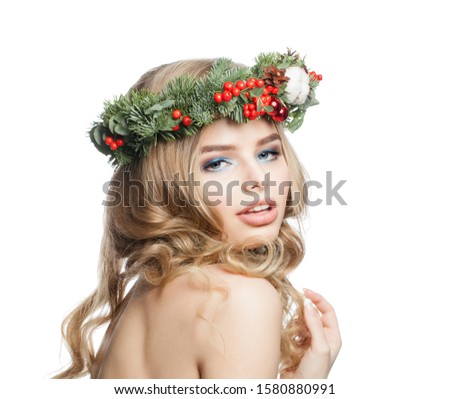 Young woman in Christmas crown wreath isolated on white