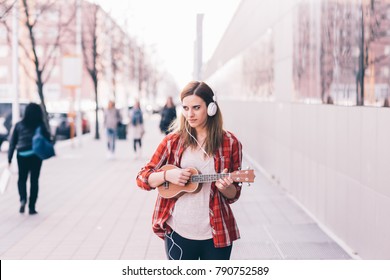 Young Woman In The City Playing Ukulele - Busker, Musician, Composer Concept