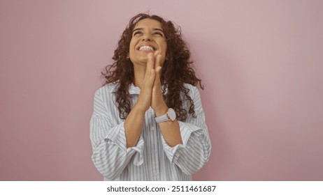 Young woman clapping hands with joy over a pink background - Powered by Shutterstock