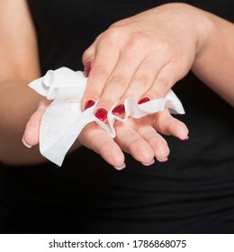 Young Woman Clean Hands With Wet Wipes. Red Nails