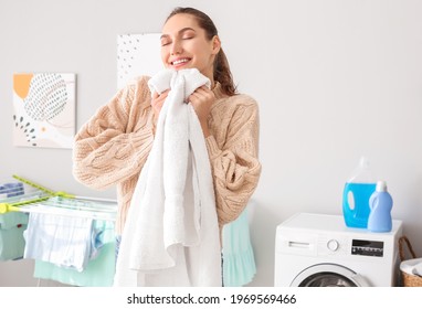 Young Woman With Clean Laundry At Home