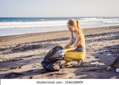 Young Woman Cleaning Up The Beach. Natural Education Of Children