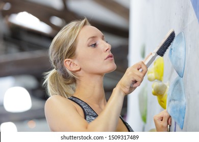 Young Woman Cleaning A Climbing Sports Gym