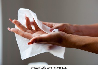 Young Woman Cleaning Hands With Wet Wipes