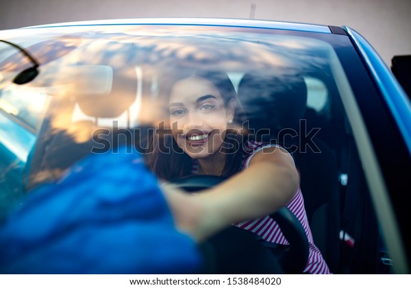 Young woman\
cleaning her car indoors.Transportation self service, care concept.\
Cleaning car interior. Woman with microfiber cloth cleaning car.\
Young woman cleaning\
auto.