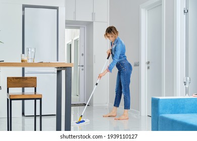 Young Woman Cleaning Her Flat With Mop