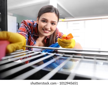 Young Woman Cleaning Oven, View From Inside