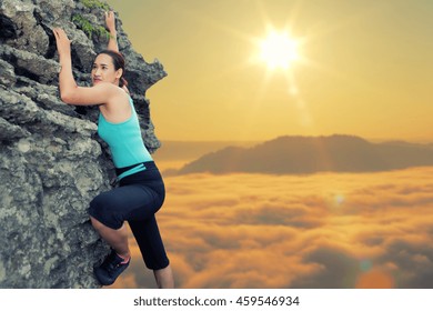 Young woman climbing natural rocky wall with enjoying sunrise natural on the background,Color vintage.
.
 - Powered by Shutterstock