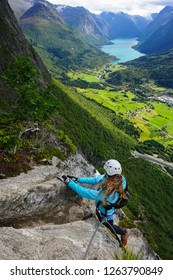 Young Woman Climbing On Via Ferrata Loen In Norway On A Sunny Day Of Summer