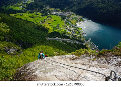 Young Woman Climbing On Via Ferrata Loen In Norway On A Sunny Day Of Summer