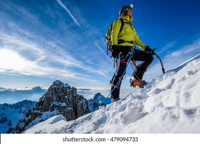 Young Woman Climbing Snow Ridge