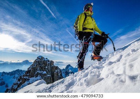Young woman climbing snow ridge