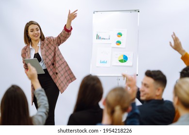 Young woman coach speaker giving flipchart presentation, speaker leading training, mentor leader explain strategy schedule at team meeting. Planning, analysis, collaborate work in teamwork. - Powered by Shutterstock