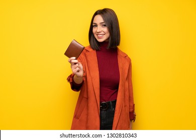 Young Woman With Coat Holding A Wallet