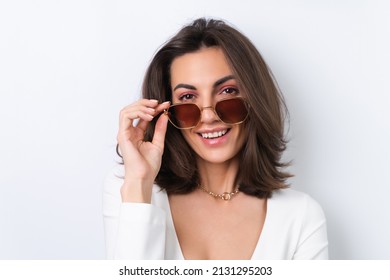 Young Woman In A Cocktail Dress, Gold Chain, Bright Spring Pink Makeup On A White Background. In Fashionable Stylish Sunglasses.