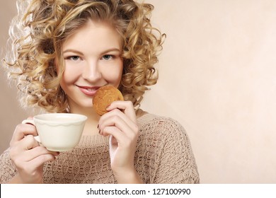 young  woman with coffee and cookies