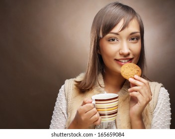 young woman with coffee and cookies