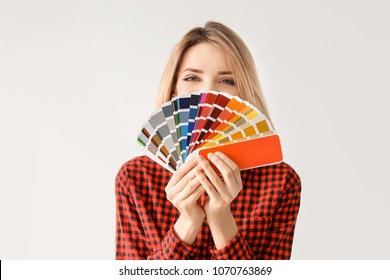 Young woman with color palette on white background - Shutterstock ID 1070763869