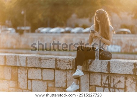 Similar – Image, Stock Photo Blonde woman looking at her smartphone outdoors