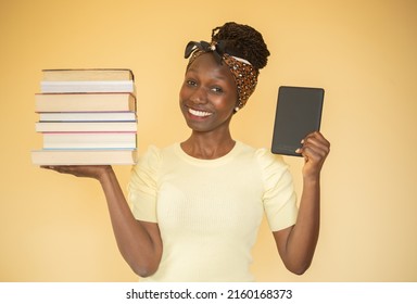 young woman comparing printed books to e-book while carrying books on her right hand and an ebook on her left hand looking at camera - Shutterstock ID 2160168373